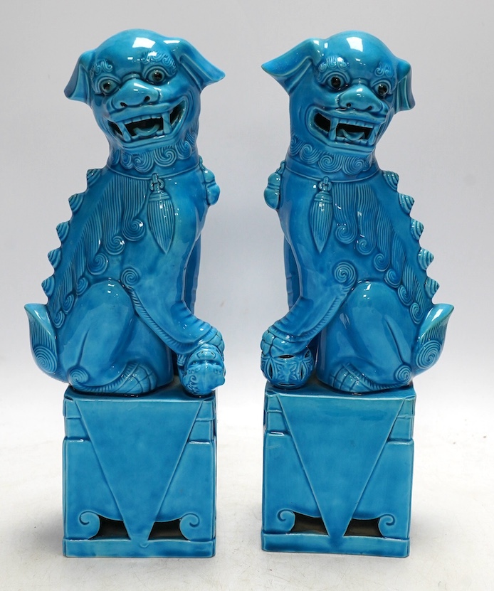 A pair of Chinese turquoise glazed lion dogs, 29cm. Condition - good